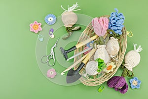 Spring planting and gardening concept. Handmade flowers with bulbs, mini tools, watering can, buckets