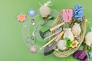 Spring planting and gardening concept. Handmade flowers with bulbs, mini tools, watering can, buckets