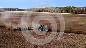 Spring plowing field tractor aerial photography with drone