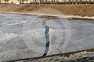 Spring pond and a crack in the ice