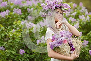 Spring portrait of a beautiful girl with lilac.