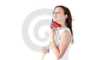 Spring portrait of young woman with healthy long hair holding red Gerber flower. Beautiful female model face. Isolated on white