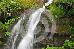 Spring rill flow in mountain photo