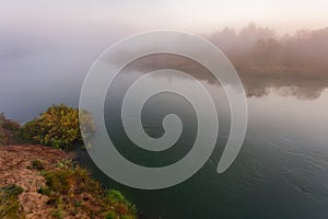 Spring river freed from ice. Spring flood on a foggy river