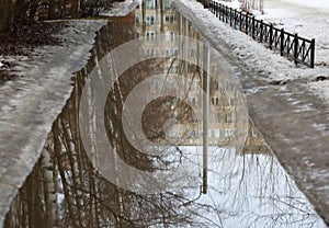 Spring road flooded with meltwater