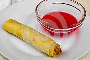 Spring roll with pink red sauce. Food on Mallorca