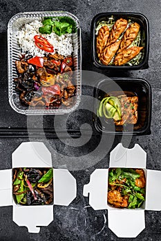 Spring rolls, dumplings, gyoza and wok noodles in Take away box. Healthy lunch. Take and go organic food. White background. Top