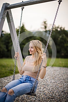 Spring romantic woman swinging on swing