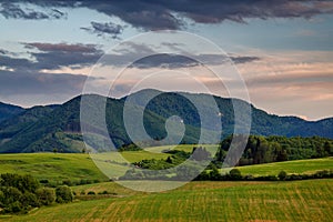 Spring rural landscape with dramatic sky at sunset