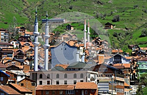 View to New mosques with two minarets in Restelica village. photo