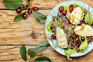 Spring salad with fried cheese and cherry