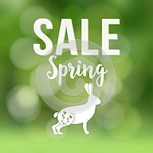 Spring sale poster with blurred background, silhouette of rabbit or hare and bokeh lights, vector illustration.