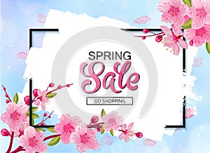 Spring sale vector banner design with flowers and frame. Cherry blossoms and blue sky background.