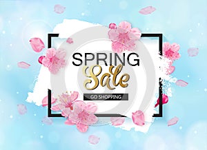 Spring sale vector banner design with flowers and frame. Cherry blossoms and blue sky background.