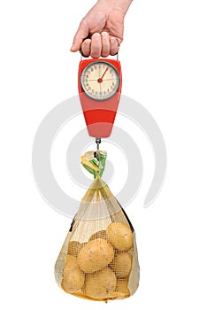 Spring scale with a bag of potatoes