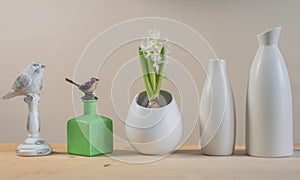 Spring Scandinavian cozy home decor: white vases, white hyacinth and bird figurines