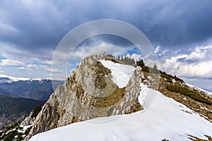 Spring scenery in the Transylvanian Alps, with snow and pine forests