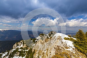 Spring scenery in the Transylvanian Alps, with snow and pine forests