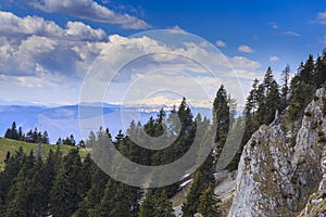 Spring scenery in the Transylvanian Alps, with snow and pine forests