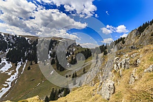 Spring scenery in the Transylvanian Alps, with snow and pine forests