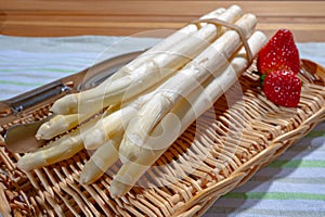 Spring season, new harvest of Dutch, German white asparagus, bunch of raw white asparagus and red strawberry