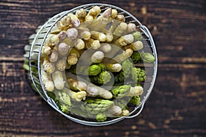 Spring season, new harvest of German white and green asparagus, bunch of raw green and white asparagus in basket with background