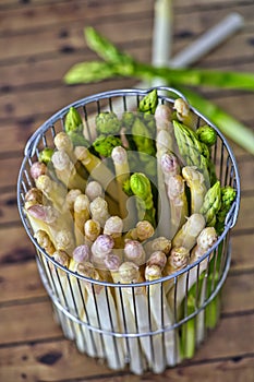 Spring season, new harvest of German white and green asparagus, bunch of raw green and white asparagus in basket with background