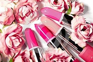 Spring set of lipsticks in pink flowers. Beauty cosmetic collection. Fashion trends in cosmetics, bright lips