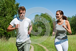 Spring - Sportive couple jogging in nature photo