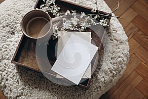 Spring still life composition. Greeting card mockup, cup of coffee. Feminine photo. Floral scene. Blurred cherry tree