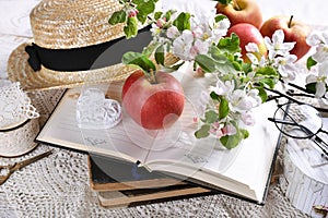 Spring still life in romantic style with apple blossoms on old books