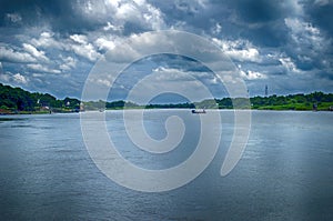 Spring summer landscape blue sky clouds Narew river boat green trees countryside