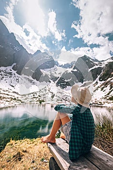 Spring summer mountain walk - boy traveler rests near beautiful