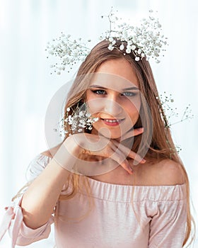 Spring and summer portrait of a young woman in flowers