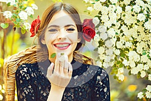 Spring, summer. Stomatology woman smiling with white flower in mouth