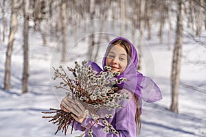 On a spring sunny day, a young girl walks, travels in the forest, collects willow for the Easter holiday. The girl walks