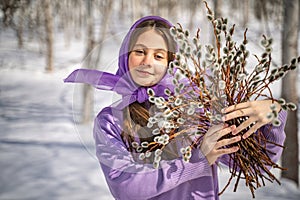 On a spring sunny day, a young girl walks, travels in the forest, collects willow for the Easter holiday. The girl walks