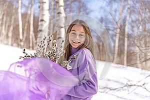 On a spring sunny day, a young girl walks, travels in the forest, collects willow for the Easter holiday. The girl walks