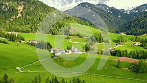 Spring sunny landscape of alpine meadow in Dolomites Alps. Famous Santa Maddalena village with church and beautiful