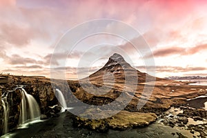 Spring sunrise over the famous Kirkjufellsfoss Waterfall with Kirkjufell mountain in the background in Iceland