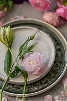 Spring table arrrangement with pink ranunculus