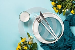 Spring table setting with flower top view.