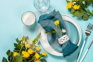 Spring table setting with flower top view.