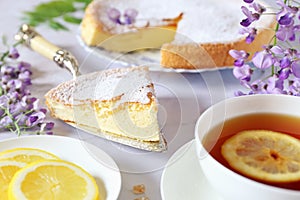 Spring tea-drinking: sponge cake, flowering wisteria and tea