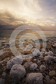 The spring thunder-storm. The coastal stones covered by salty adjournment