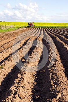 Spring tillage in the ground and tractor photo