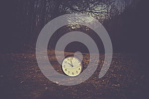 Spring Time Change. Summer back concept. Vintage alarm Clock outdoors