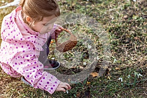 Spring time- cute little girl picking snowdrop flowers in spring