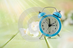 Spring time daylight saving concept - with alarm clock and flowers