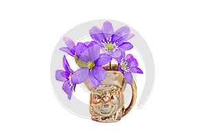 Spring time violet flowers in small brass vase isolated on white